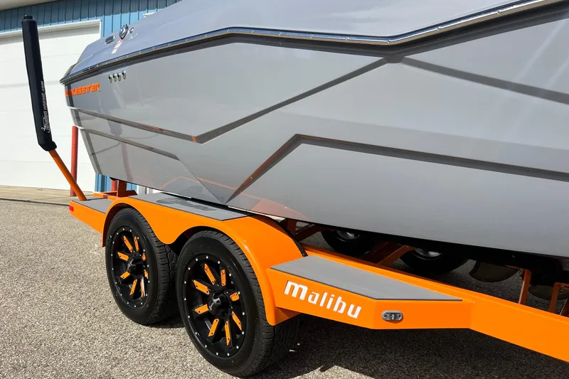 Slide: The Image of 2023 Malibu Wakesetter 22 LSV on orange trailer, showcasing sleek design and branding. - 6