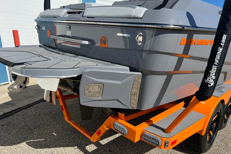 Slide: The Image of 2023 Malibu Wakesetter 22 LSV boat, gray and orange, rear view on trailer. - 7