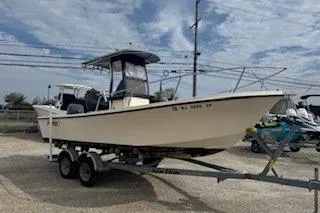 The Image of 2001 Parker 2100 Special Edition boat on trailer, parked outdoors under cloudy sky. - 0