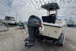 Slide: The Image of 2001 Parker 2100 Special Edition boat with Yamaha outboard motor, docked on gravel. - 2