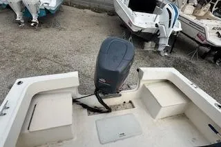 Slide: The Image of 2001 Parker 2100 Special Edition boat with outboard motor, docked on gravel. - 3