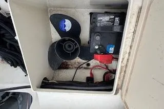 Slide: The Image of Battery and propeller storage in 2001 Parker 2100 Special Edition boat compartment. - 8