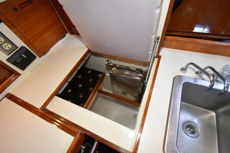 Slide: The Image of 1988 Ericson 38-200 yacht interior showing sink and storage compartment. - 17