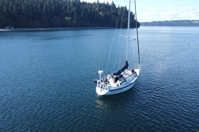 Slide: The Image of Sailboat Ericson 38-200 (1988) on calm water near forested shoreline. - 2
