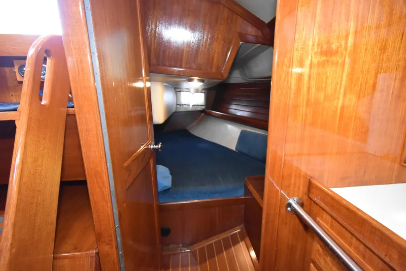 Slide: The Image of Interior cabin of 1988 Ericson 38-200 sailboat with wooden finish and cozy sleeping area. - 20