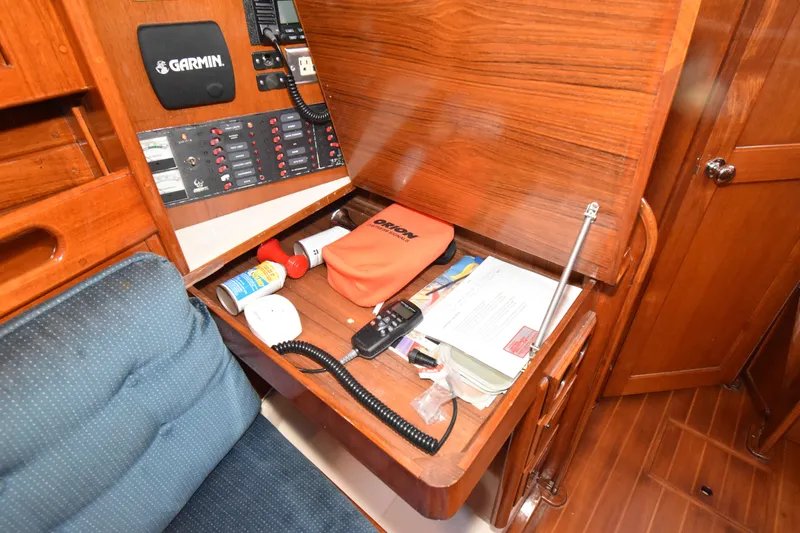 Slide: The Image of Navigation station on 1988 Ericson 38-200 sailboat with Garmin equipment and storage. - 23