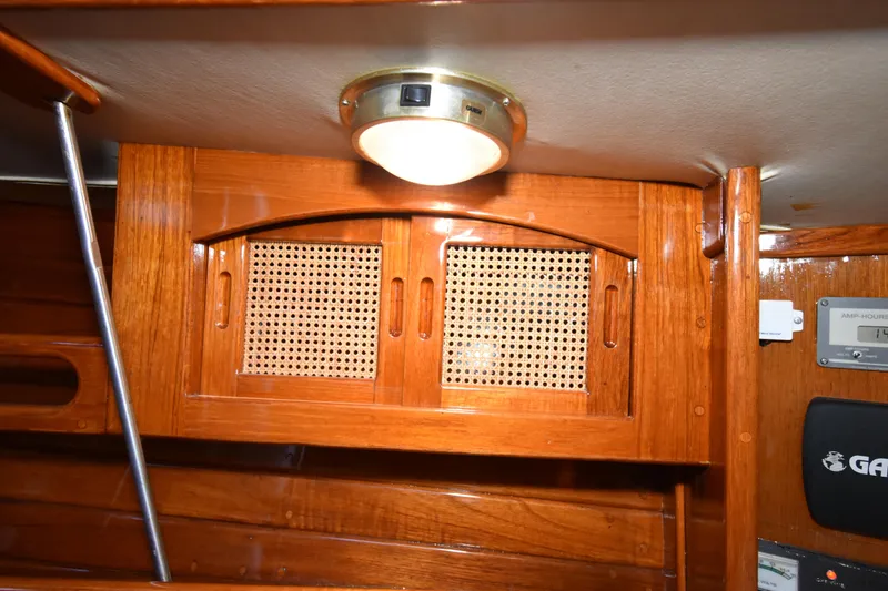 Slide: The Image of Interior of 1988 Ericson 38-200 sailboat with wooden cabinetry and overhead light. - 25