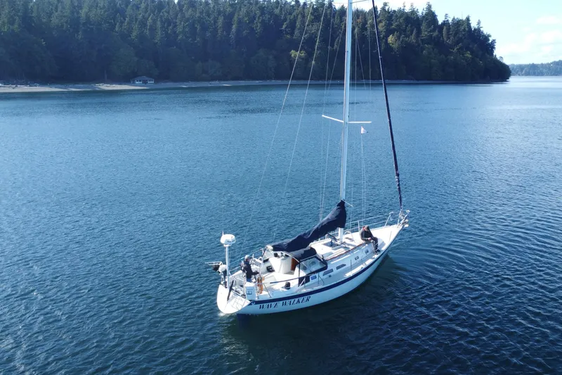 Slide: The Image of Sailboat Ericson 38-200 (1988) on calm water near forested shoreline. - 3