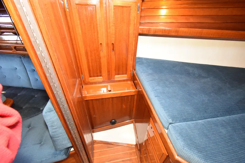Slide: The Image of Interior of 1988 Ericson 38-200 sailboat with wooden cabinetry and blue upholstery. - 30