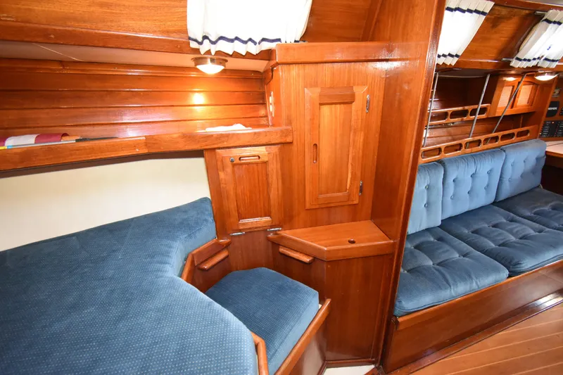Slide: The Image of Interior of 1988 Ericson 38-200 sailboat with wooden cabinetry and blue upholstery. - 31