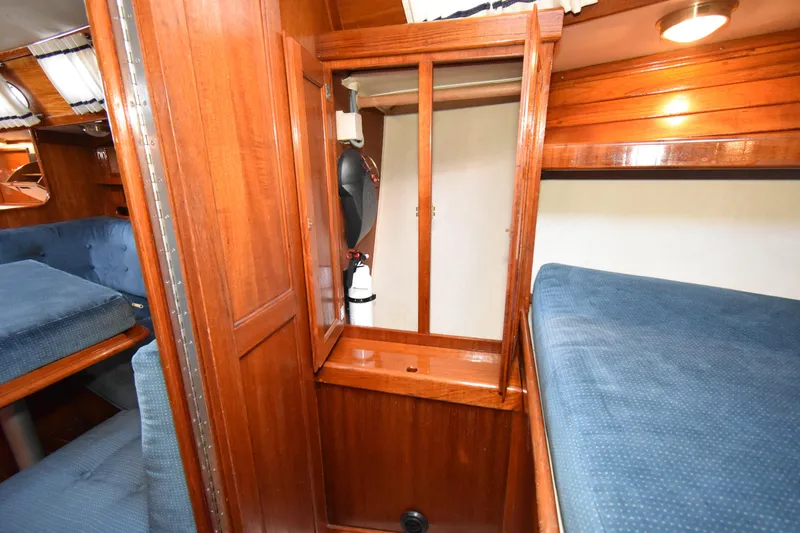 Slide: The Image of Interior of 1988 Ericson 38-200 sailboat with wooden cabinetry and blue upholstery. - 32