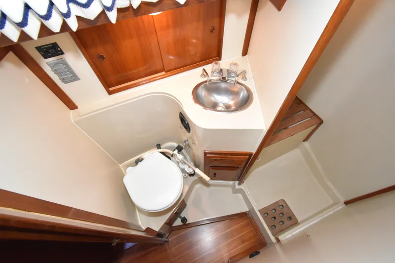 Slide: The Image of Compact bathroom in 1988 Ericson 38-200 yacht with sink, toilet, and wooden accents. - 34