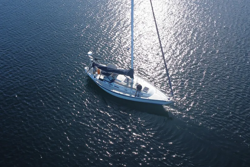 Slide: The Image of Aerial view of 1988 Ericson 38-200 sailboat gliding on shimmering water. - 4