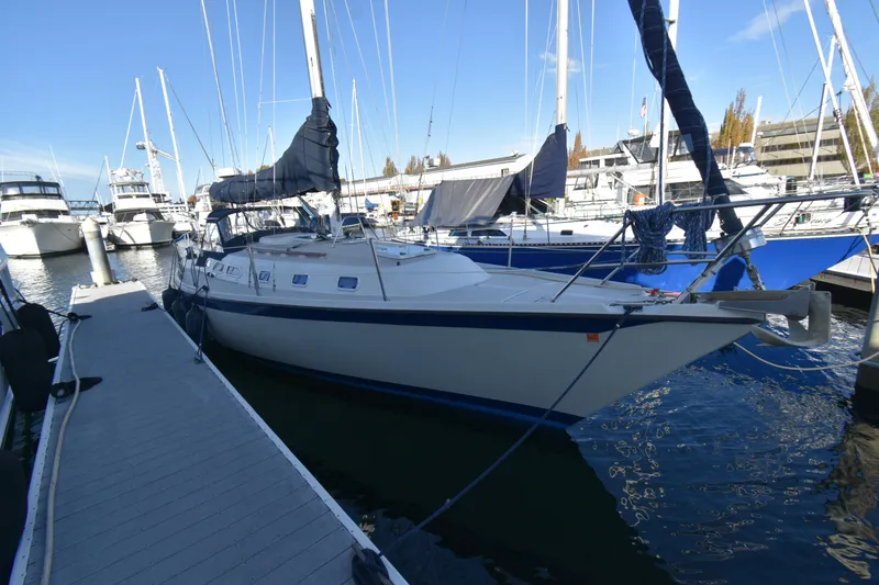 Slide: The Image of 1988 Ericson 38-200 sailboat docked at marina, surrounded by other boats. - 40