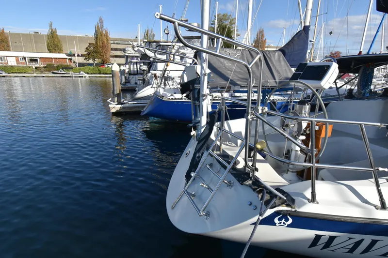 Slide: The Image of 1988 Ericson 38-200 sailboat docked in a marina on a sunny day. - 43