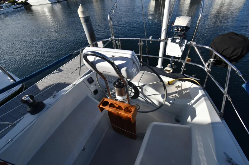 Slide: The Image of Cockpit of 1988 Ericson 38-200 sailboat with steering wheel and navigation equipment. - 48