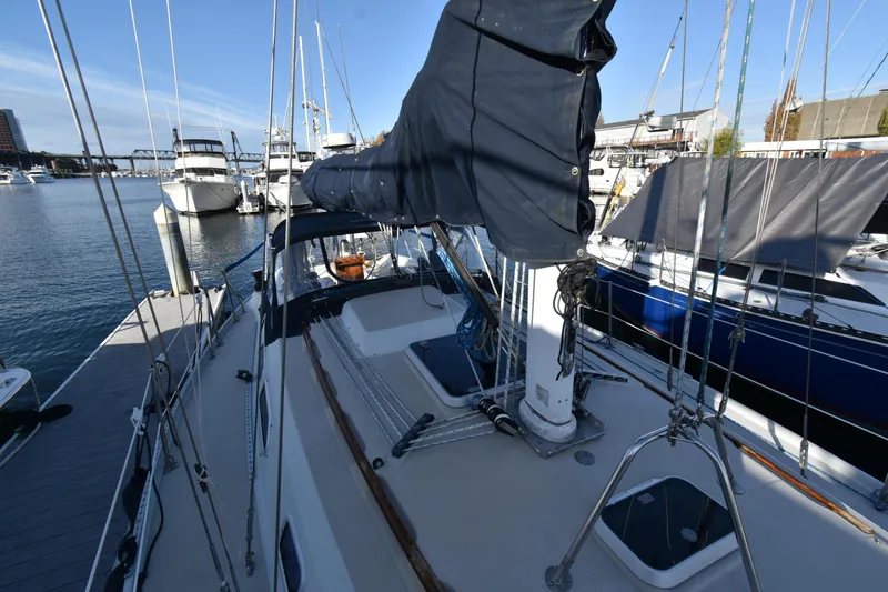 Slide: The Image of 1988 Ericson 38-200 sailboat docked at marina, featuring deck and rigging. - 51