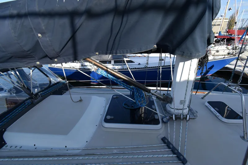 Slide: The Image of 1988 Ericson 38-200 sailboat deck with rigging and covered boom in marina. - 52