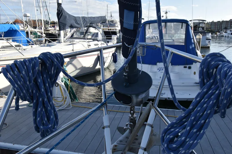 Slide: The Image of Sailboat docked at marina, featuring Ericson 38-200, 1988 model, with coiled ropes. - 56