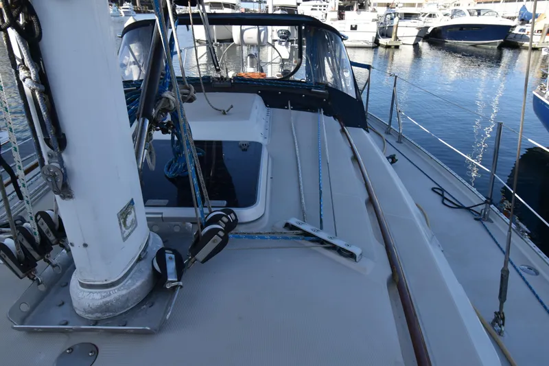 Slide: The Image of 1988 Ericson 38-200 sailboat deck with rigging and marina view. - 59