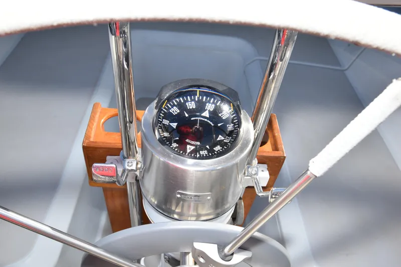 Slide: The Image of Compass and steering wheel on 1988 Ericson 38-200 sailboat cockpit. - 63