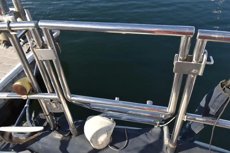 Slide: The Image of Stainless steel railing on 1988 Ericson 38-200 sailboat, docked by calm water. - 65