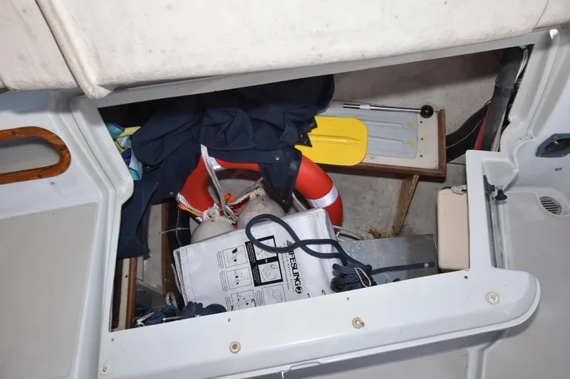 Slide: The Image of Storage compartment on 1988 Ericson 38-200 sailboat with life ring, ropes, and equipment. - 66