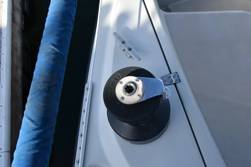 Slide: The Image of Winch on 1988 Ericson 38-200 sailboat deck, with blue rope and cleat. - 71