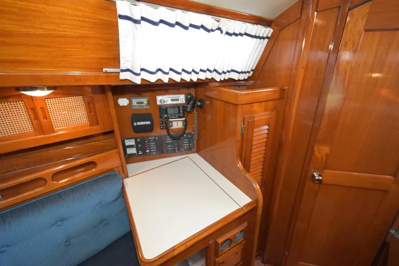 Slide: The Image of 1988 Ericson 38-200 yacht interior with navigation equipment and wooden cabinetry. - 8