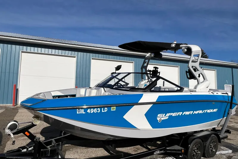 Slide: The Image of 2020 Super Air Nautique G21 boat in blue and white, parked on a trailer. - 3
