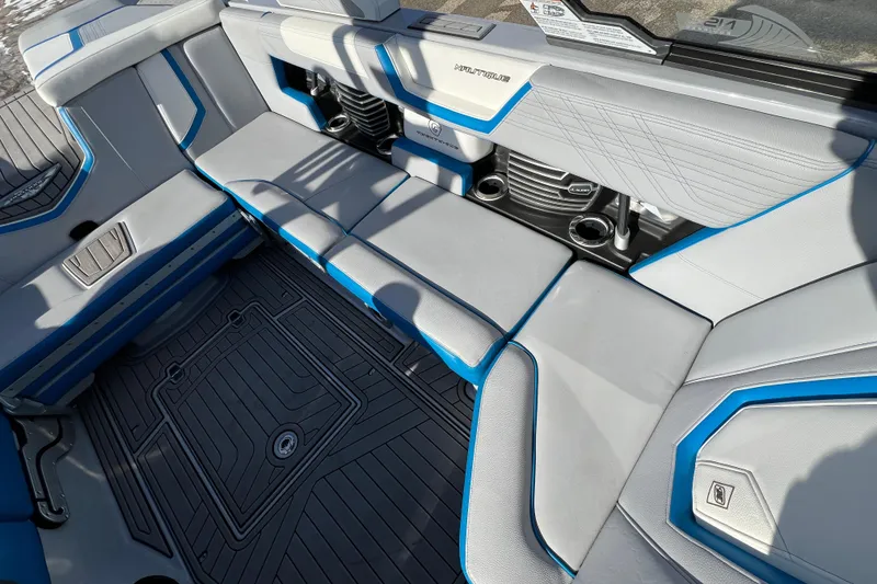 Slide: The Image of 2020 Super Air Nautique G21 interior with gray and blue seating, cup holders, and sleek design. - 31