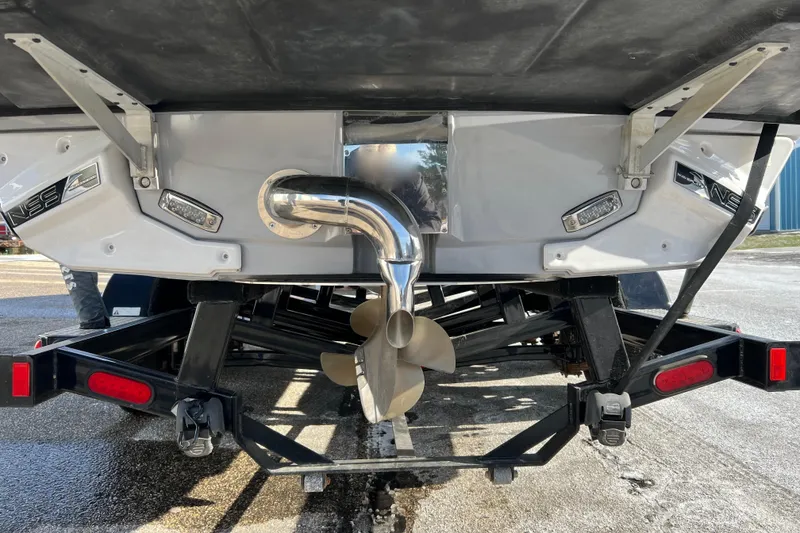 Slide: The Image of Rear view of 2020 Super Air Nautique G21 boat on trailer, showing propeller and exhaust. - 36