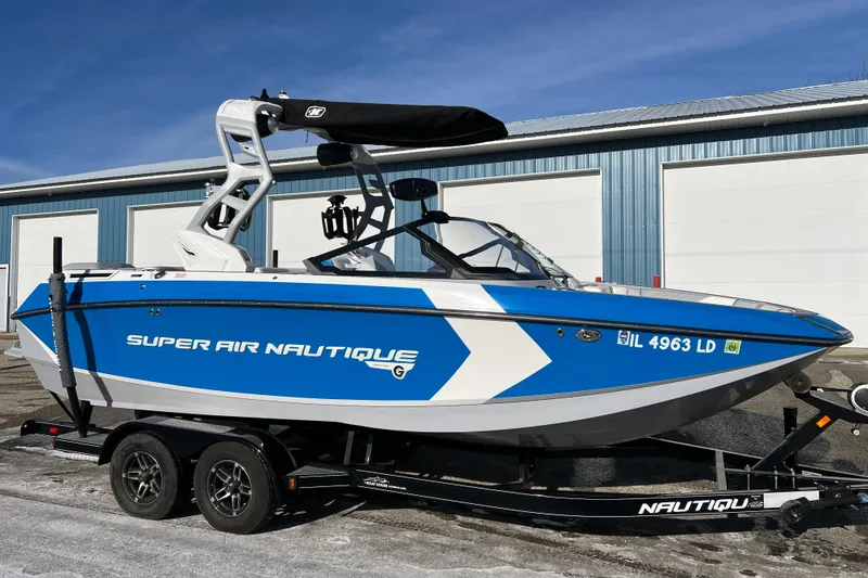 Slide: The Image of 2020 Super Air Nautique G21 boat in blue and white on trailer. - 9