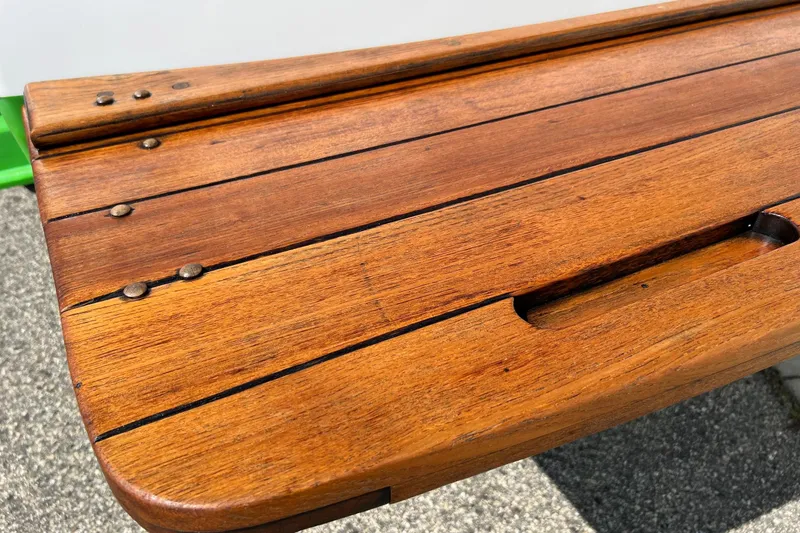 Slide: The Image of Wooden deck of a 2003 MasterCraft X-5 boat, featuring polished finish and metal fasteners. - 16