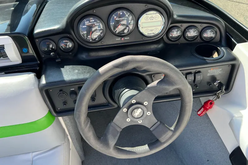 Slide: The Image of 2003 MasterCraft X-5 boat dashboard with steering wheel and instrument panel. - 19