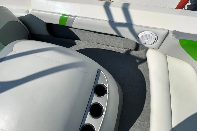 Slide: The Image of Interior of 2003 MasterCraft X-5 boat with white and green upholstery, cup holders, and speaker. - 24