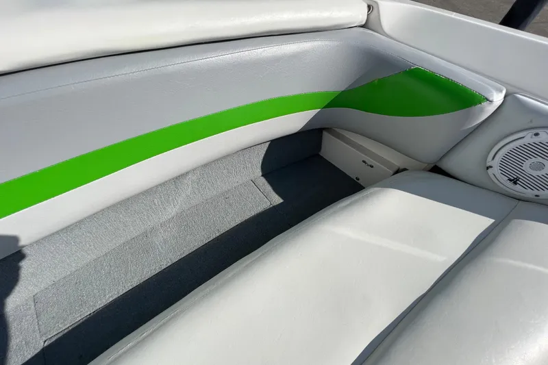 Slide: The Image of 2003 MasterCraft X-5 boat interior with green accents and speaker. - 28