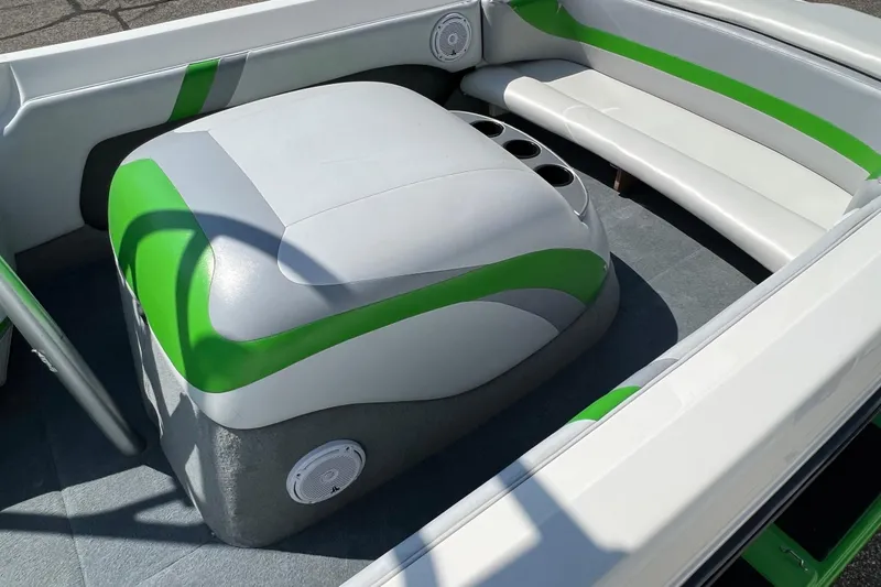 Slide: The Image of 2003 MasterCraft X-5 boat interior with green and white seating and cup holders. - 3