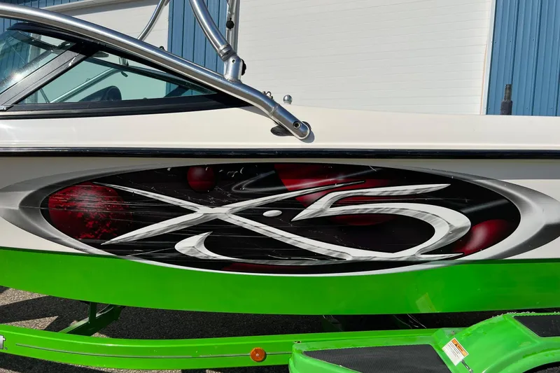 Slide: The Image of 2003 MasterCraft X-5 boat with vibrant green detailing and bold graphics. - 31