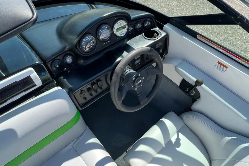 Slide: The Image of 2003 MasterCraft X-5 boat interior with steering wheel and dashboard controls. - 5