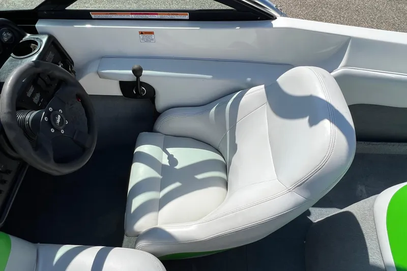 Slide: The Image of 2003 MasterCraft X-5 boat interior with white seating and steering wheel. - 6