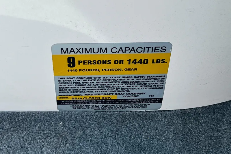 Slide: The Image of 2003 MasterCraft X-5 capacity label, maximum 9 persons or 1440 lbs, safety compliance details. - 9