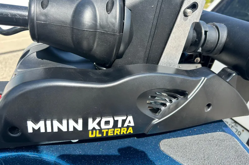 Slide: The Image of Open storage compartment on 2005 Skeeter WX1880 DC boat, featuring carpeted interior and cup holders. - 16