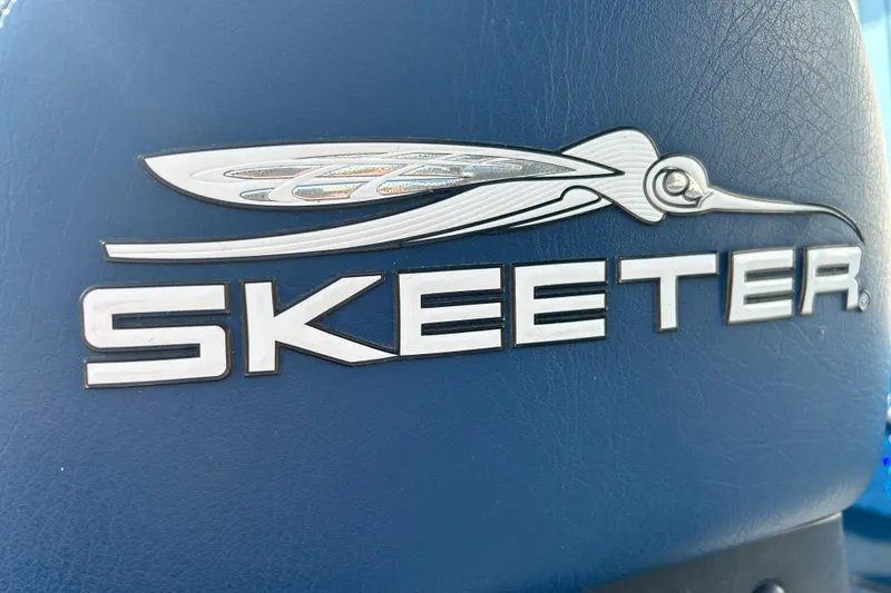 Slide: The Image of 2005 Skeeter WX1880 DC boat with blue metallic finish and bold logo. - 30