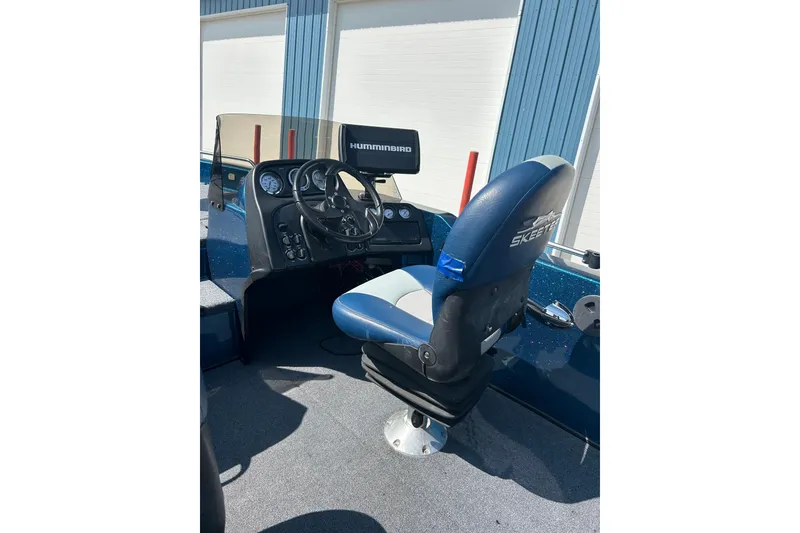 Slide: The Image of 2005 Skeeter WX1880 DC boat interior with seating and steering console. - 32