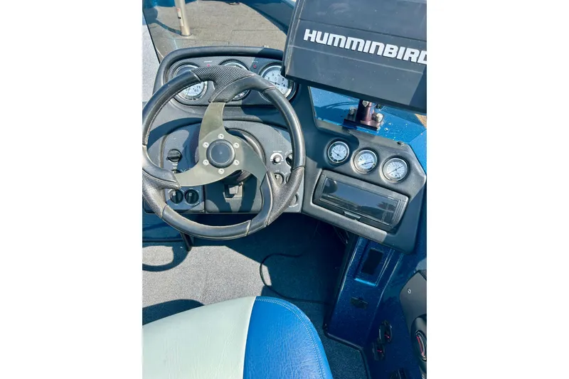 Slide: The Image of 2005 Skeeter WX1880 DC boat dashboard with steering wheel and Humminbird display. - 8