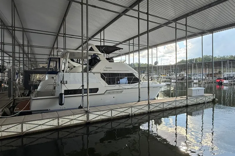 The Image of 1993 Carver 390 Cockpit Motor Yacht docked in a covered marina. - 0