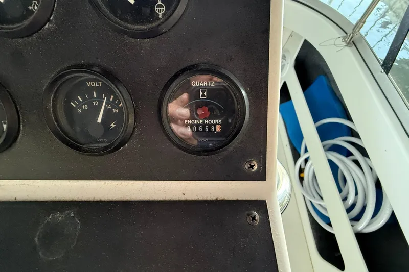Slide: The Image of Control panel of 1993 Carver 390 Cockpit Motor Yacht showing voltmeter and engine hours. - 16