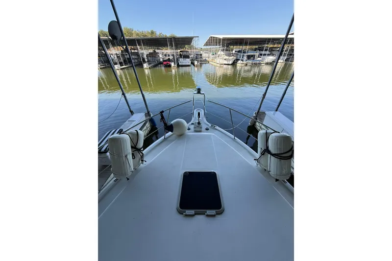 Slide: The Image of 1993 Carver 390 Cockpit Motor Yacht docked at marina, clear sky, calm water. - 19
