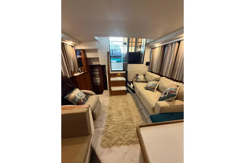 Slide: The Image of Luxurious interior of 1993 Carver 390 Cockpit Motor Yacht with cozy seating and elegant decor. - 22